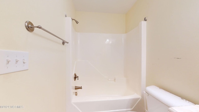 bathroom with shower / bathtub combination and toilet