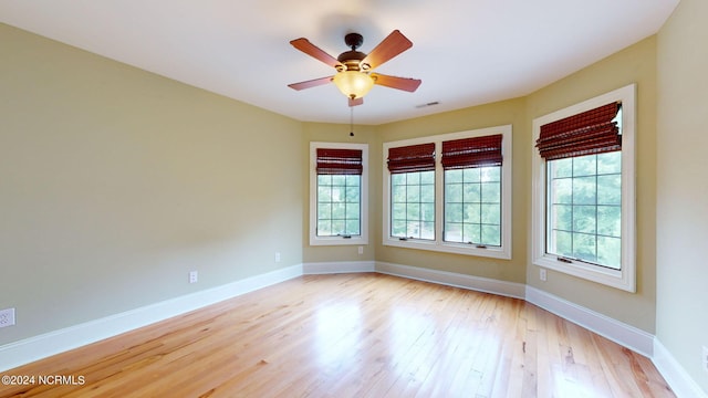 unfurnished room with ceiling fan and light wood-type flooring