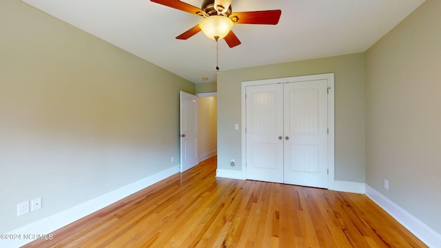 unfurnished bedroom featuring a closet, light hardwood / wood-style floors, and ceiling fan