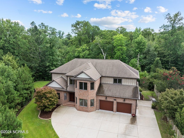 view of front of house featuring a garage and a front lawn