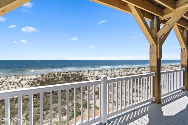 wooden terrace with a water view and a beach view