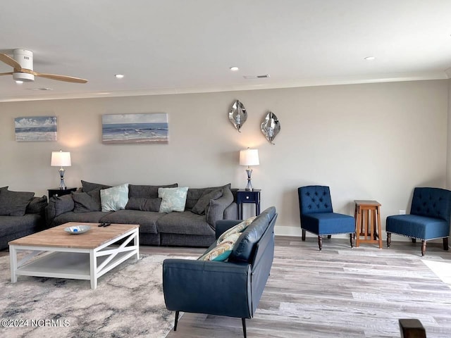 living area featuring light wood finished floors, visible vents, a ceiling fan, ornamental molding, and recessed lighting