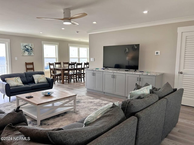 living area featuring ornamental molding, recessed lighting, ceiling fan, and light wood-style flooring