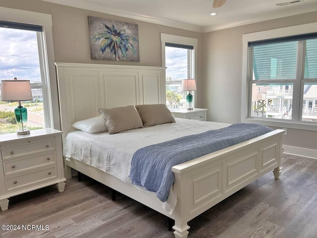 bedroom with recessed lighting, visible vents, baseboards, dark wood-style floors, and crown molding