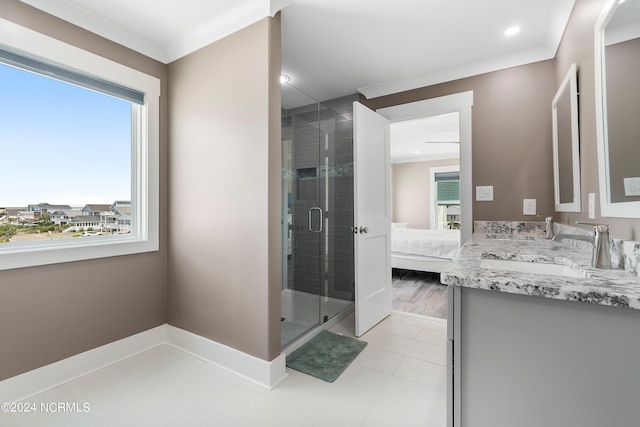 ensuite bathroom featuring a stall shower, ensuite bath, baseboards, and vanity