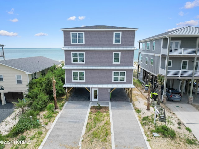 beach home featuring a carport and a water view