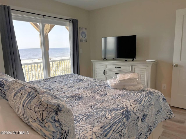 bedroom with access to outside and light wood-style flooring