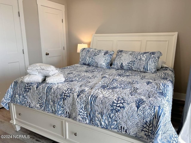 bedroom with dark wood-style flooring