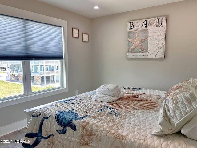 bedroom with baseboards and wood finished floors