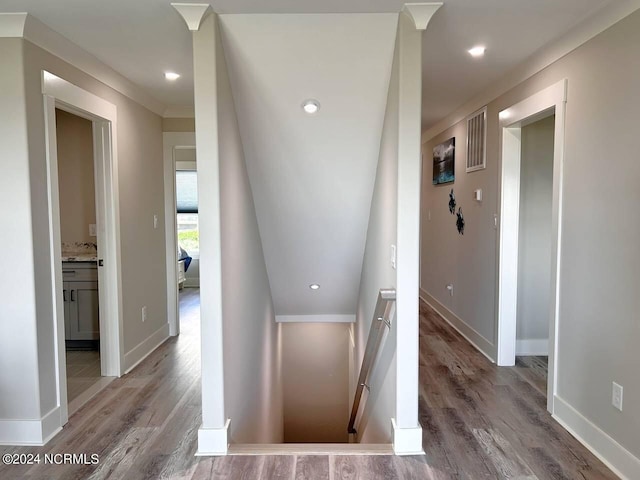 hall featuring baseboards, recessed lighting, an upstairs landing, and light wood-style floors