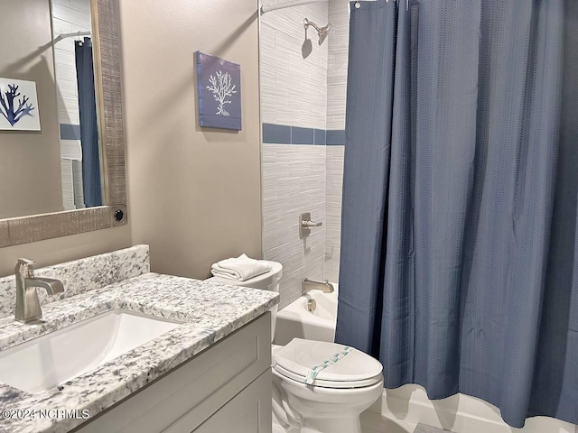 bathroom with toilet, shower / bath combo, and vanity