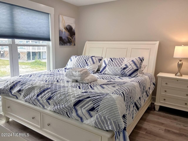 bedroom with dark wood-type flooring