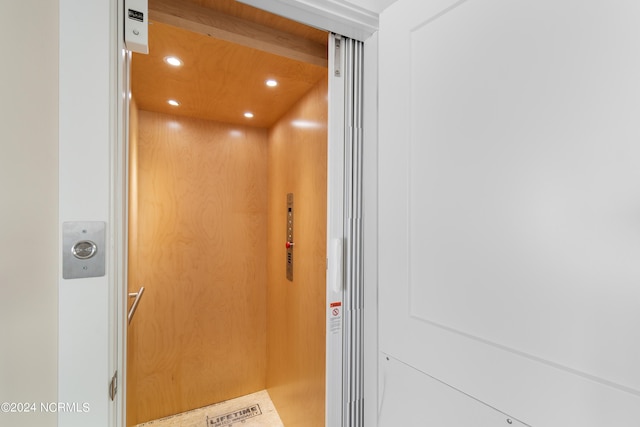 interior details featuring elevator and recessed lighting