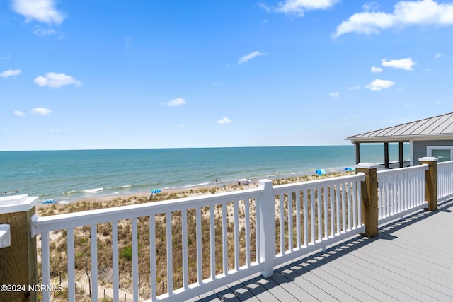 deck featuring a water view and a view of the beach