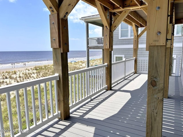 deck with a water view and a beach view