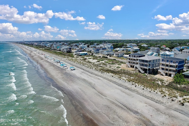 aerial view with a water view and a beach view