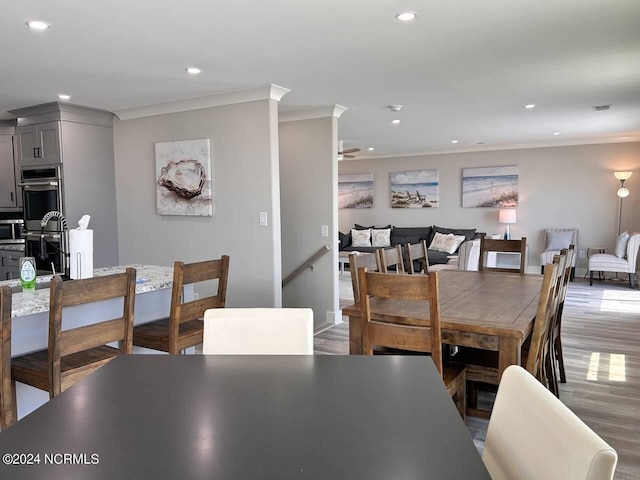 dining space featuring visible vents, ornamental molding, wood finished floors, and recessed lighting