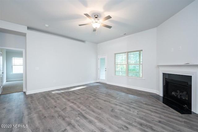 unfurnished living room featuring hardwood / wood-style flooring and ceiling fan