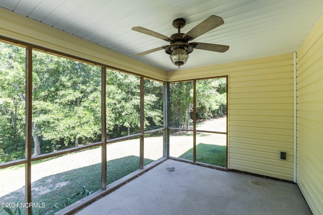 unfurnished sunroom featuring ceiling fan