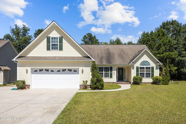 view of front of property with a garage and a front yard