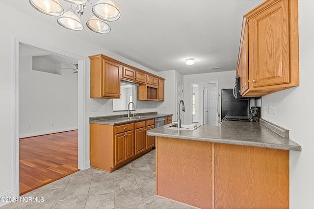 kitchen featuring sink, light tile patterned floors, stainless steel appliances, and ceiling fan