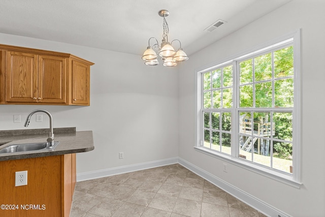 kitchen with hanging light fixtures, sink, and a notable chandelier