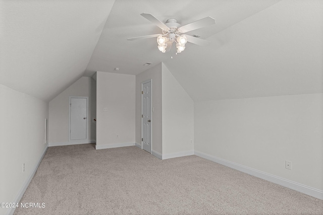 additional living space with lofted ceiling, light colored carpet, and ceiling fan