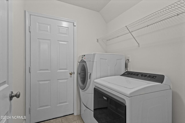 clothes washing area featuring washer and clothes dryer