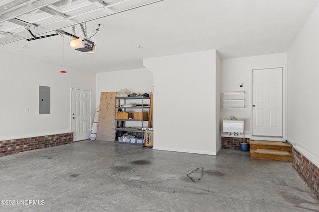 garage with sink, a garage door opener, and electric panel