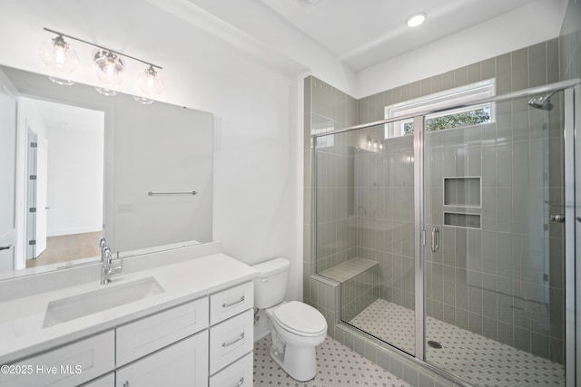 full bathroom featuring tile patterned floors, toilet, a stall shower, and vanity