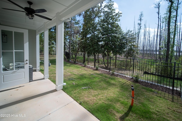 view of yard featuring a patio area, ceiling fan, and fence
