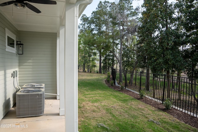 view of yard featuring cooling unit, fence, and a ceiling fan