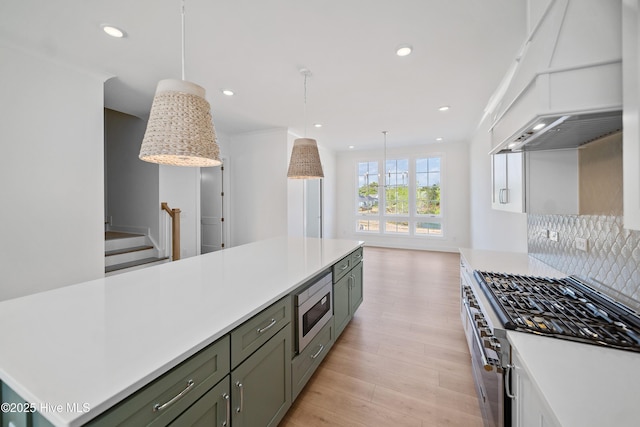kitchen with premium range hood, light countertops, and stainless steel appliances