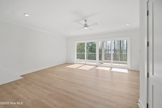 unfurnished room with ornamental molding, ceiling fan, light wood-type flooring, and baseboards