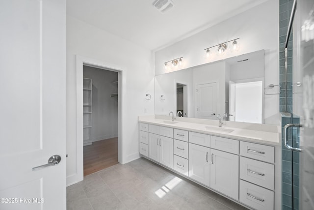 full bath with double vanity, visible vents, a sink, and a stall shower