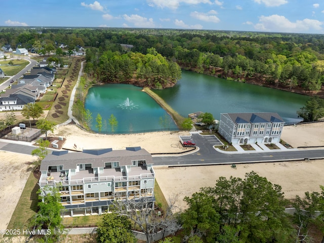 bird's eye view featuring a forest view and a water view