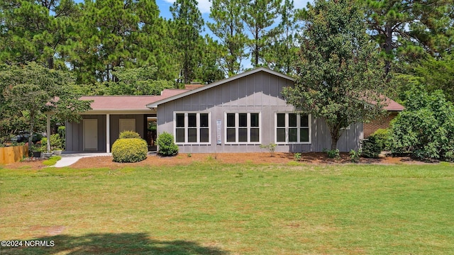 rear view of house featuring a yard