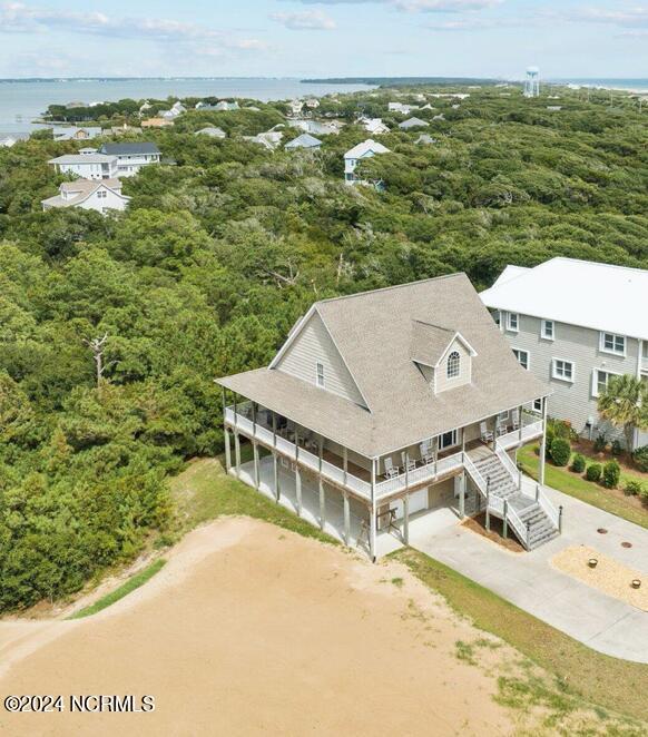 view of front facade with a water view, a porch, and a garage