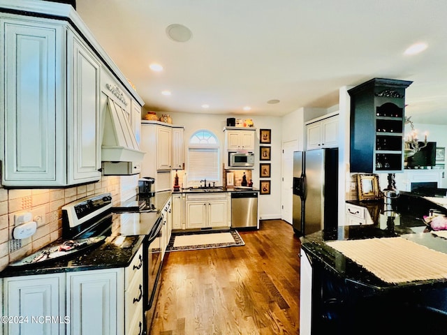 kitchen featuring stainless steel appliances, white cabinetry, dark hardwood / wood-style floors, and custom range hood