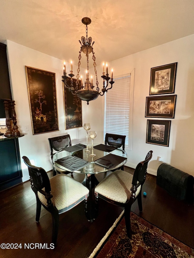 dining area featuring a notable chandelier and dark hardwood / wood-style floors