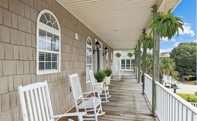 view of front of house featuring covered porch, central AC unit, and a garage