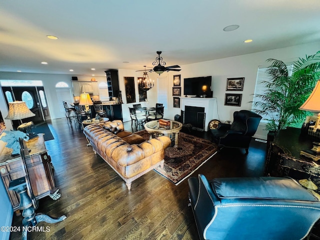 living room featuring ceiling fan and dark hardwood / wood-style floors