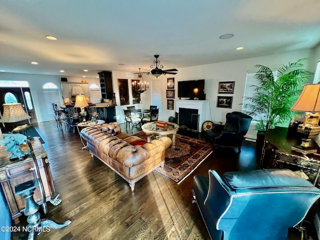 living room featuring dark hardwood / wood-style flooring and ceiling fan