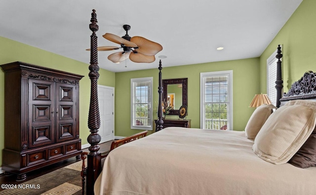 bedroom with ceiling fan and dark wood-type flooring