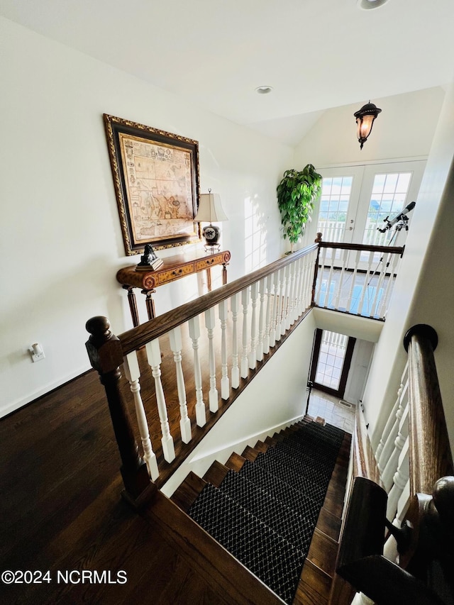 staircase with french doors and hardwood / wood-style floors