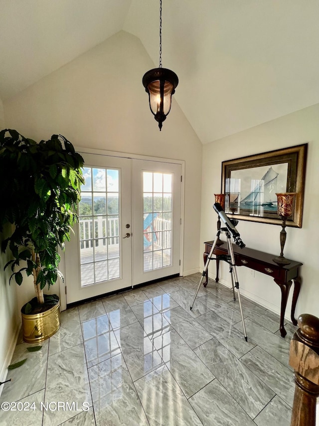 entryway featuring high vaulted ceiling and french doors