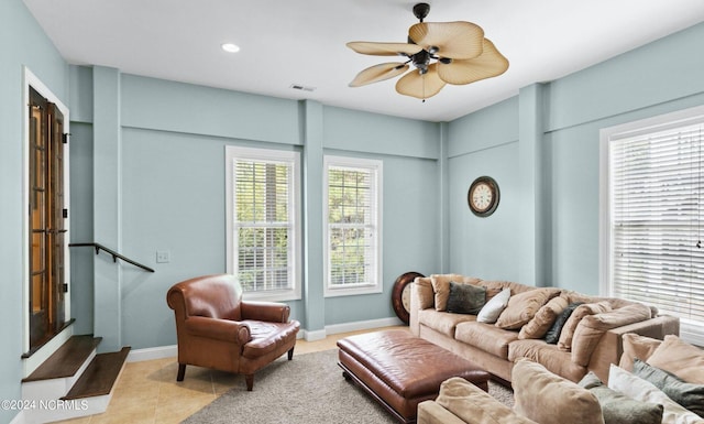 tiled living room featuring ceiling fan and a healthy amount of sunlight