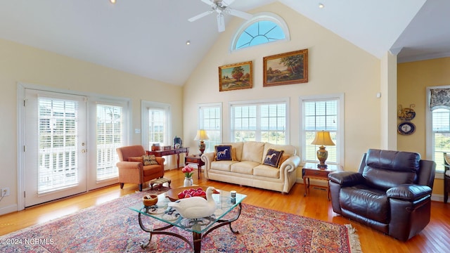 living room with high vaulted ceiling, hardwood / wood-style floors, ceiling fan, and a wealth of natural light