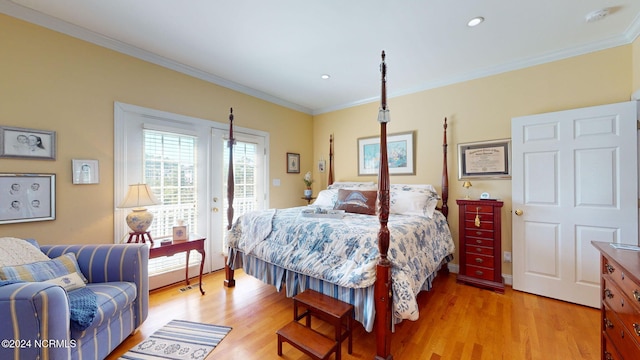 bedroom featuring crown molding, hardwood / wood-style floors, and access to exterior