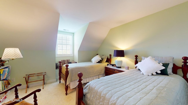 bedroom with lofted ceiling and light colored carpet